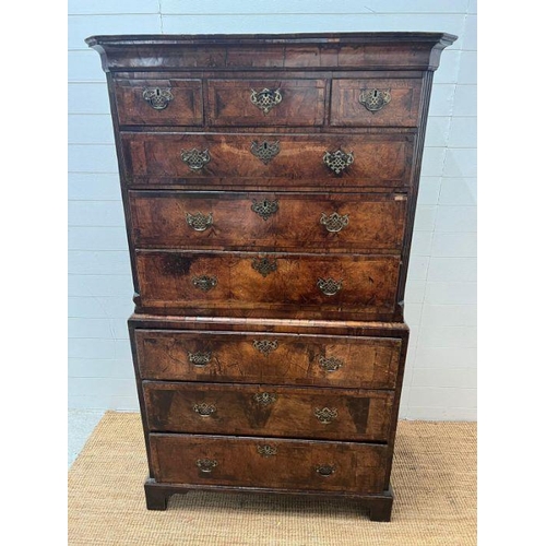 33 - A George III style chest on chest, three small drawers followed by graduated drawers below, two piec... 