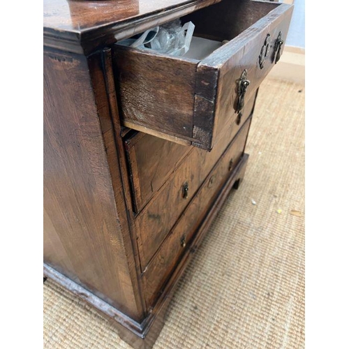 34 - A walnut chest of drawers, two over three with brass drop handles and on bracket feet (Approximate M... 
