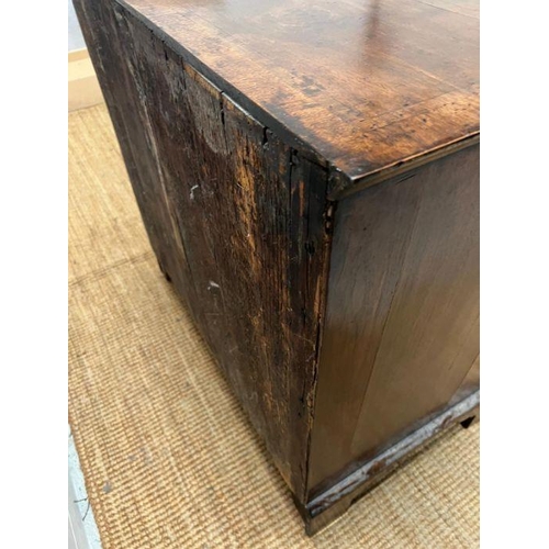 34 - A walnut chest of drawers, two over three with brass drop handles and on bracket feet (Approximate M... 