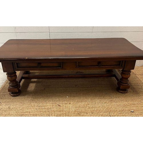 39 - An oak coffee table on turned legs and drawers to centre (H42cm W139cm D63cm)