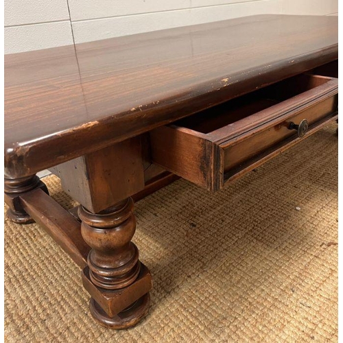 39 - An oak coffee table on turned legs and drawers to centre (H42cm W139cm D63cm)