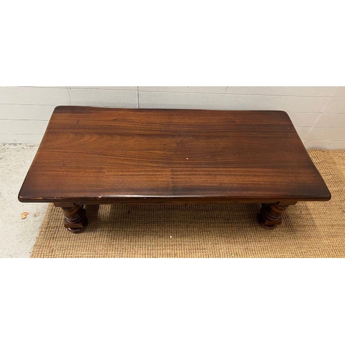 39 - An oak coffee table on turned legs and drawers to centre (H42cm W139cm D63cm)