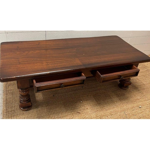 39 - An oak coffee table on turned legs and drawers to centre (H42cm W139cm D63cm)