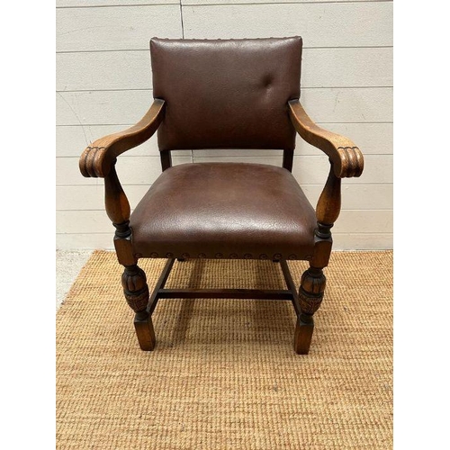 4 - An oak brown leather studded upholstered open armchair on carved legs