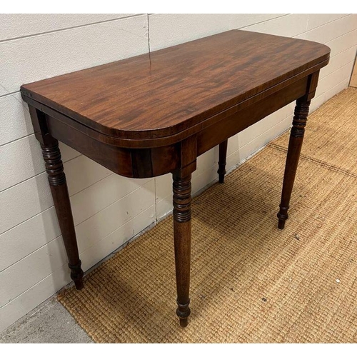 41 - A mahogany card table on turned legs (H75cm W92cm D44cm)