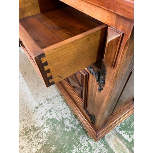 46 - A long hardwood sideboard on bun feet consisting of four drawers and four cupboards with wrought iro... 