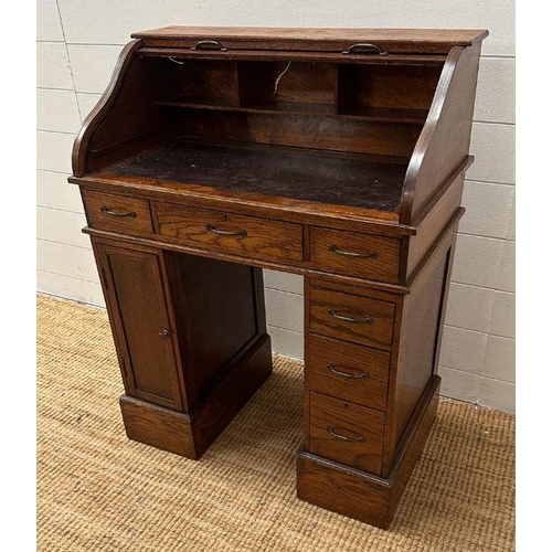 48 - An oak small or child's pedestal roll top desk, six drawers and single cupboards and chair   (H91cm ... 