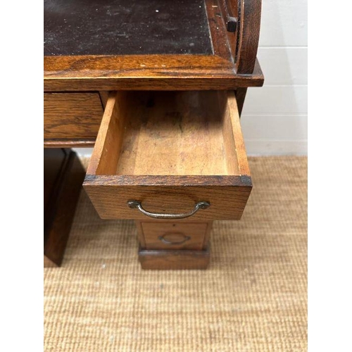 48 - An oak small or child's pedestal roll top desk, six drawers and single cupboards and chair   (H91cm ... 