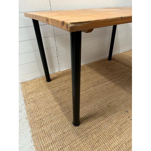 49 - A pine topped table on black metal legs (H73cm W120cm)
