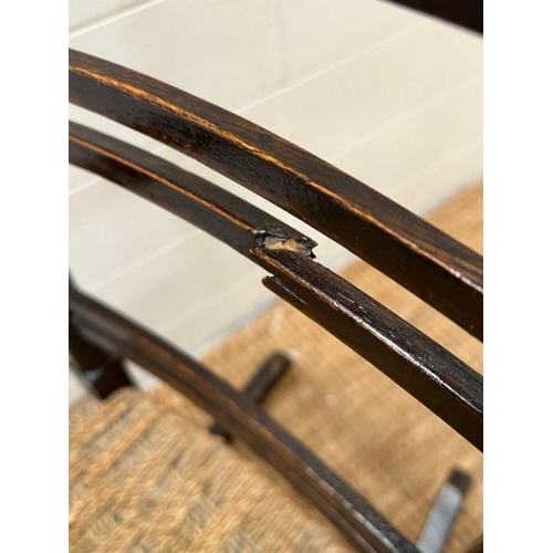 52 - An oak child's rocking chair with reeded seat on inlaid to back