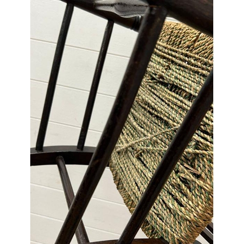 52 - An oak child's rocking chair with reeded seat on inlaid to back
