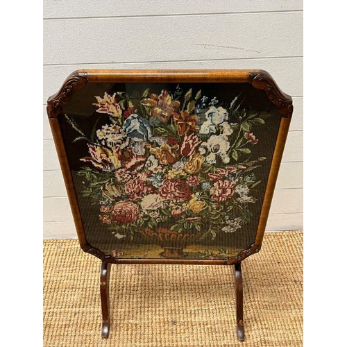 54 - A walnut framed fore screen with needle work to centre