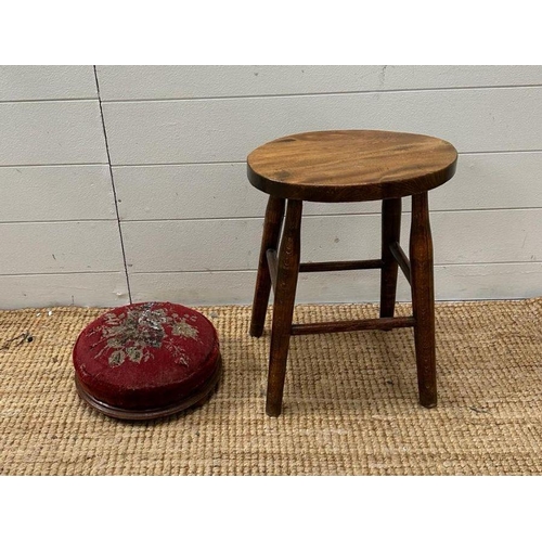 59 - A small oak stool and a red ground floral upholstered foot stool