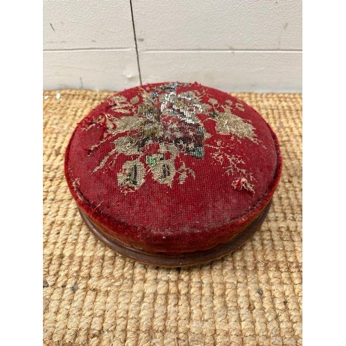 59 - A small oak stool and a red ground floral upholstered foot stool
