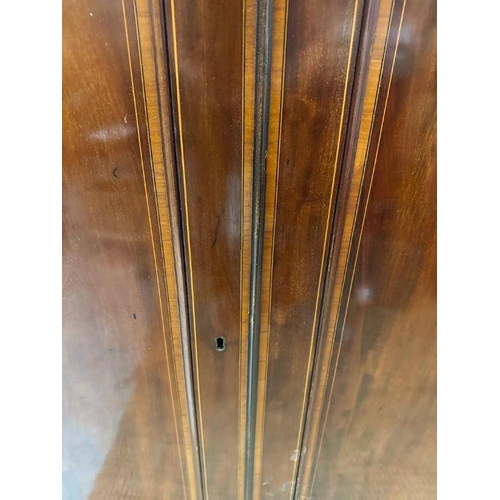 6 - A mahogany gentleman's wardrobe with fruitwood inlay, central doors leading to cupboard with hanging... 