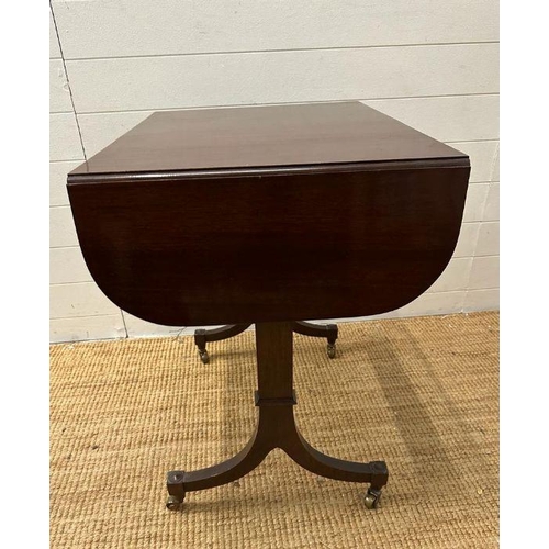 7 - A mahogany drop leaf occasional table on splayed legs with castors (H 73cm x D 51cm x W108cm)