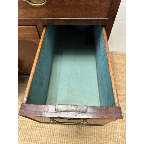 8 - An oak kneehole desk with centre cupboard flanked by three drawers to left and right with brass drop... 