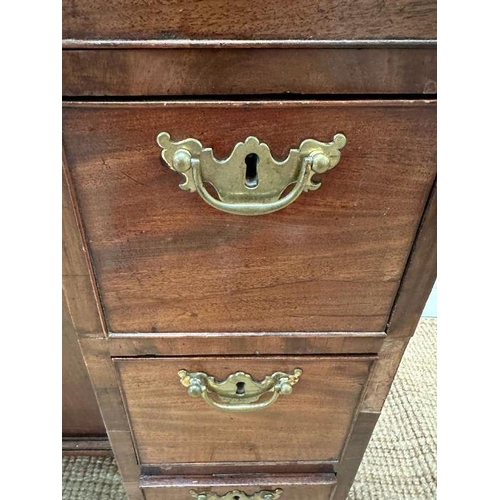 8 - An oak kneehole desk with centre cupboard flanked by three drawers to left and right with brass drop... 