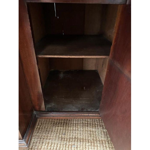 8 - An oak kneehole desk with centre cupboard flanked by three drawers to left and right with brass drop... 