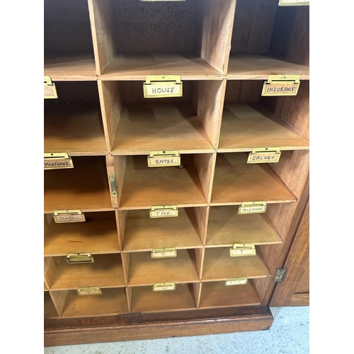 1 - An oak postmaster pigeon hole sorting cupboard made up of twenty four sorting departments (H66cm D26... 