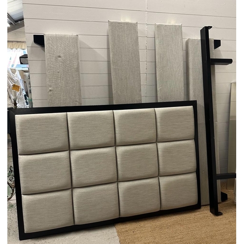 113 - A queen sized bed with a wall hanging grey block headboard