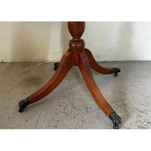 116 - A mahogany circular side table with string inlaid on lion paw feet and castors (H65cm Dia54cm)