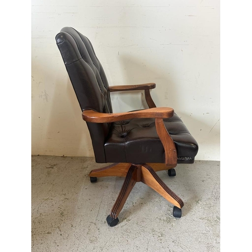 118 - A  faux brown leather button back desk chair on castors (H94cm W58cm D50cm)