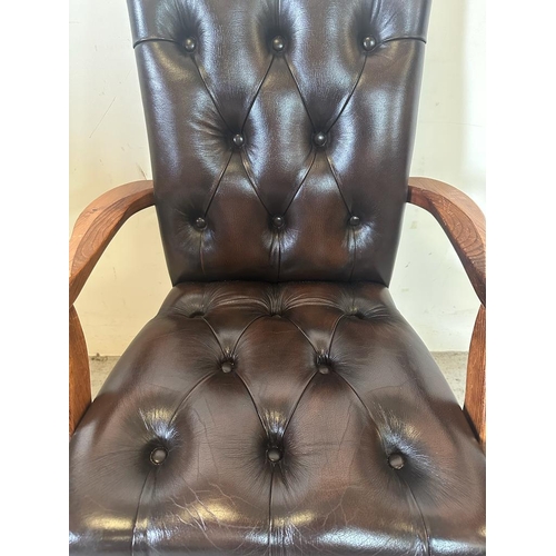 118 - A  faux brown leather button back desk chair on castors (H94cm W58cm D50cm)