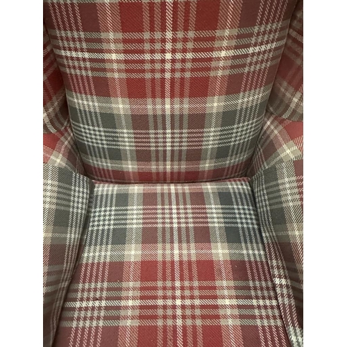 14 - A check upholstered wing back arm chair and matching foot stool