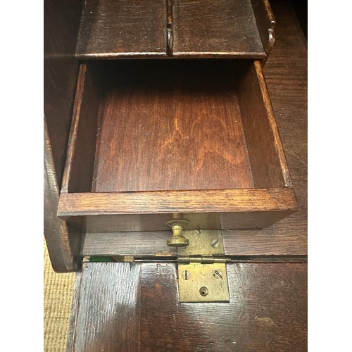 144 - An oak bookcase bureau with single cupboard and single drawer and two shelf over (H157cm W74cm D45cm... 