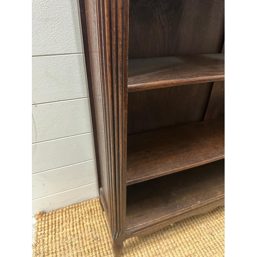 149 - A four shelf oak bookcase with two drawers over and carved floral gallery (H117cm W93cm D23cm)