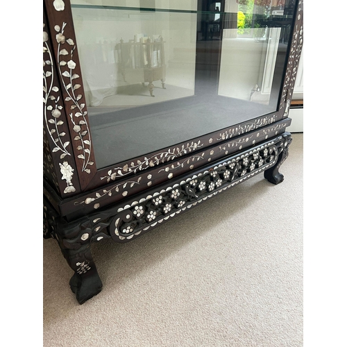 162 - A hardwood, double side opening Chinese display cabinet with mother of pearl inlay and three glass s... 