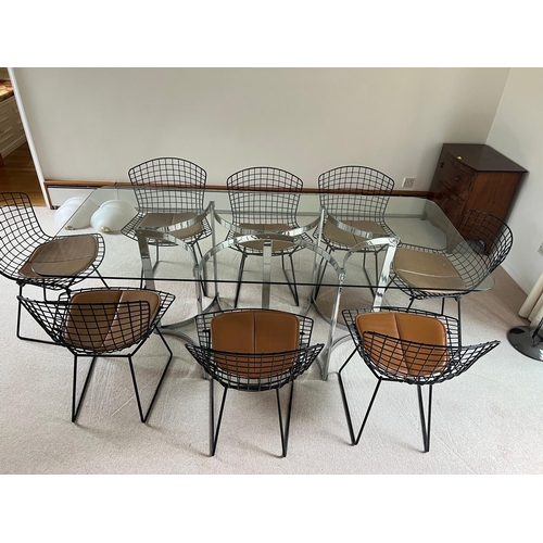 167 - A set of eight Harry Bertoia chairs with brown leather seat pads and a Merrow Associates glass table... 