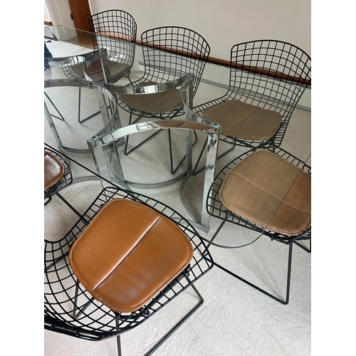 167 - A set of eight Harry Bertoia chairs with brown leather seat pads and a Merrow Associates glass table... 