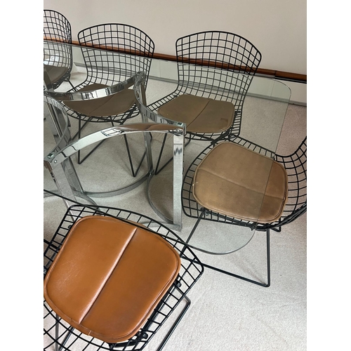 167 - A set of eight Harry Bertoia chairs with brown leather seat pads and a Merrow Associates glass table... 