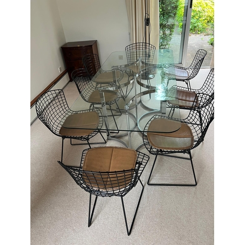 167 - A set of eight Harry Bertoia chairs with brown leather seat pads and a Merrow Associates glass table... 