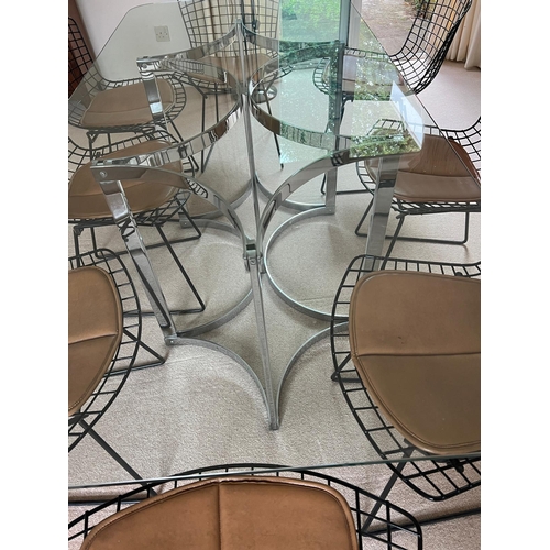 167 - A set of eight Harry Bertoia chairs with brown leather seat pads and a Merrow Associates glass table... 