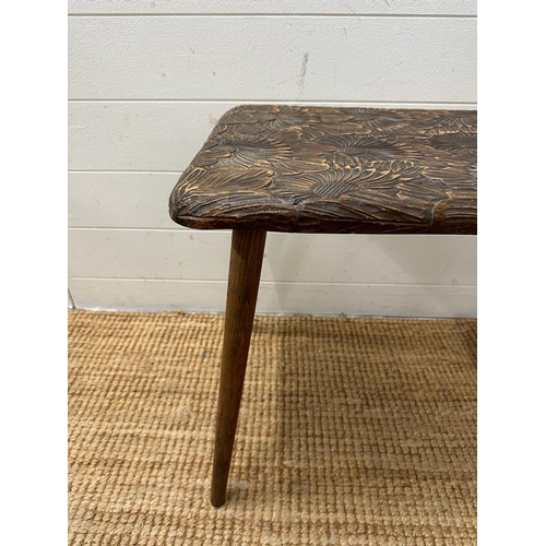 186 - An oak side table with carved floral top (H49cm W64cm D40cm)