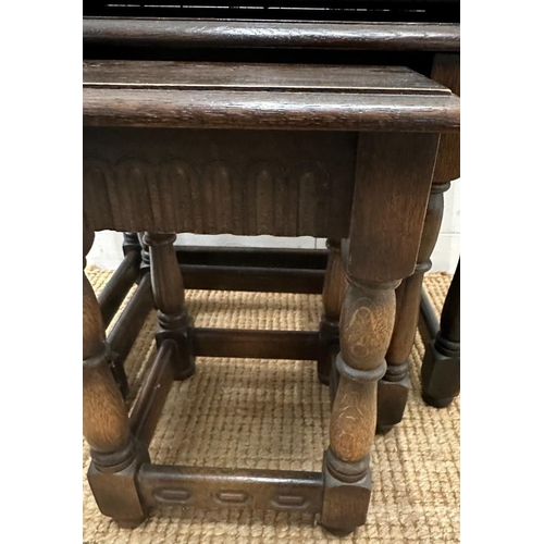 189 - A nest of three dark oak Mid Century side tables (H48cm W61cm D37cm)