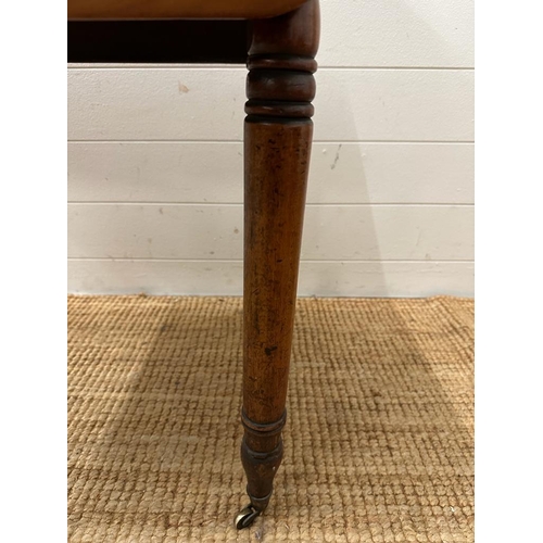 196 - A mahogany single drawer Pembroke table on turned legs and castors