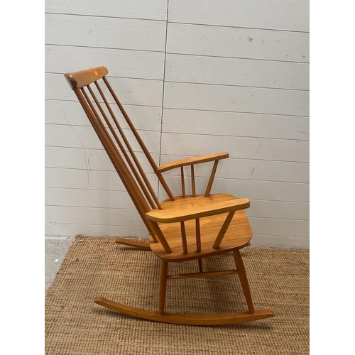 206 - A Mid Century teak Windsor stick back rocking chair