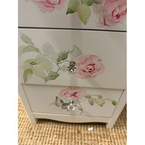 215 - A pair white painted three drawer bedside tables with rose motif (H60cm W42cm D32cm)