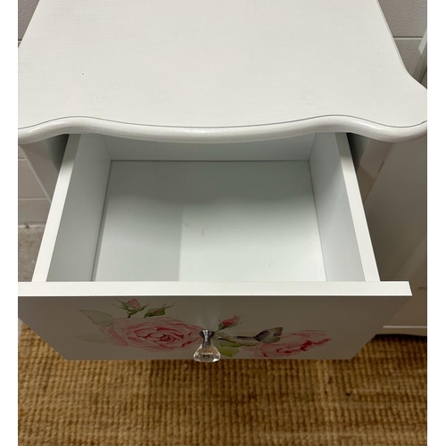 215 - A pair white painted three drawer bedside tables with rose motif (H60cm W42cm D32cm)