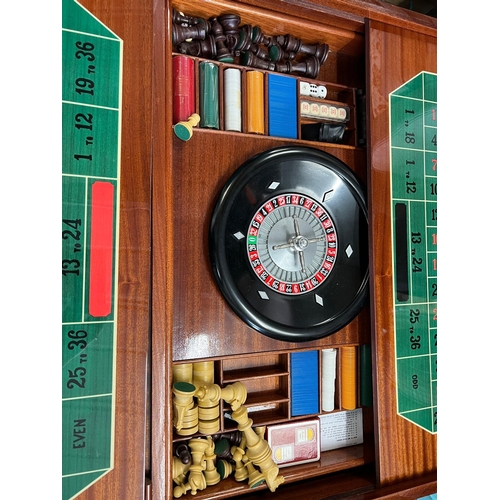 218 - An Italian inlaid games table with roulette, chest and including games pieces