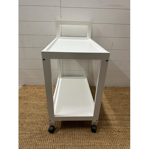 221 - A cotemporary white tea trolley on castors (H74cm D35cm W60cm)