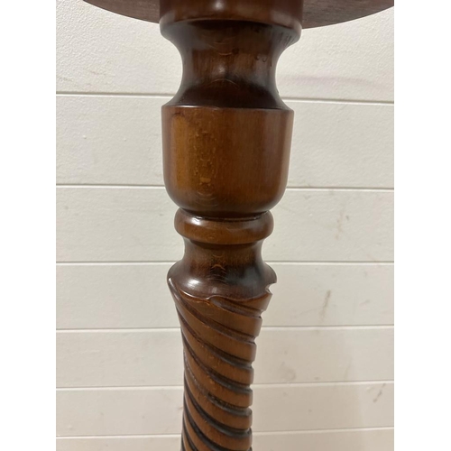 223 - A mahogany plant stand on turned central column (H93cm Dia26cm)