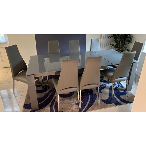 23 - A Calligaris  extending dining room table and eight chairs (Extended H75cm W220cm D90cm)