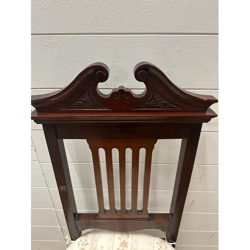 231 - An Edwardian style mahogany hall chair with carved relief and turned front legs