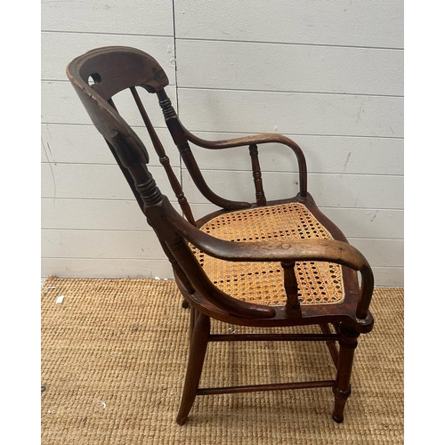 246 - A Victorian oak his and hers stick back chairs with cane seat s