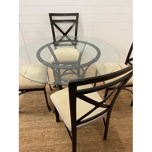 249 - A contemporary glass and metal dining table with four chairs (H75cm Dia114cm)